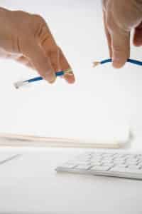 Hands splicing wires above a keyboard