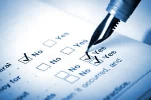 Pen checking "Yes" and "No" boxes on a form 