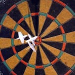 Darts hitting bulls-eye